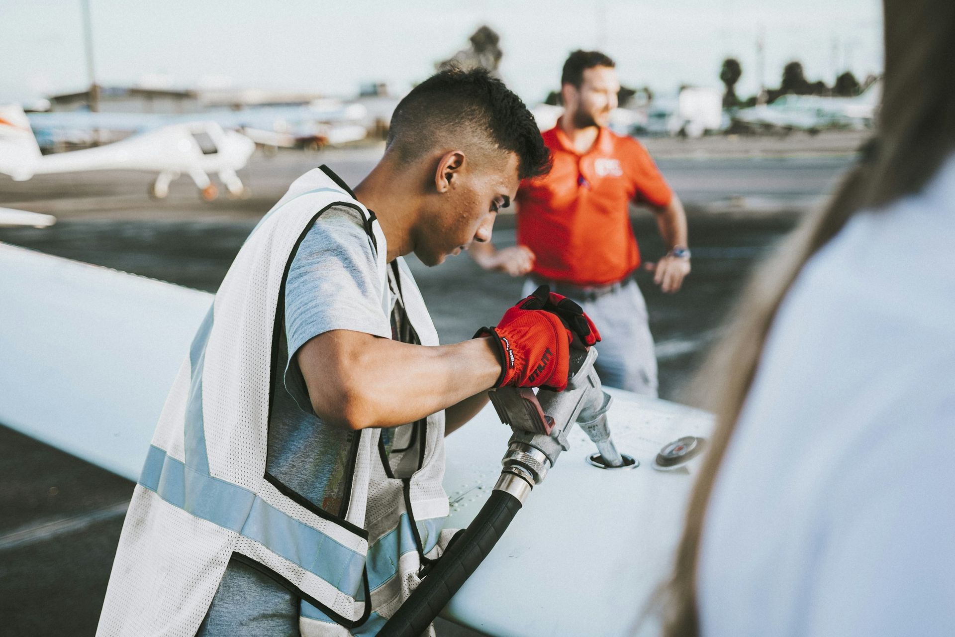 Line technician fueling an aircraft at the wing