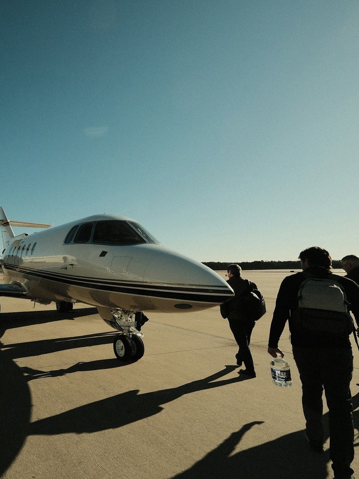 Crew walking out to a business jet on the ramp